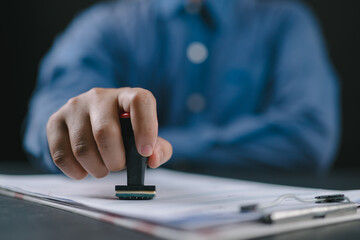 Fototapeta premium Sign Approved Stamp On Document to permit and certify for work document and visa At Desk