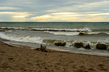 waves on brown sand beach at first light suitable as background backdrop room for text shot kew beach toronto