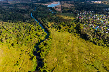 Quadcopter view of a picturesque rural landscape with a small river Luzha. Maloyaroslavetsky...