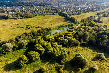 Quadcopter view of a picturesque rural landscape with a small river Luzha. Maloyaroslavetsky...