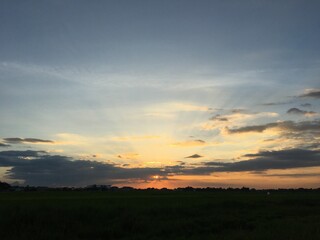 Sunset covered in clouds with sun rays 