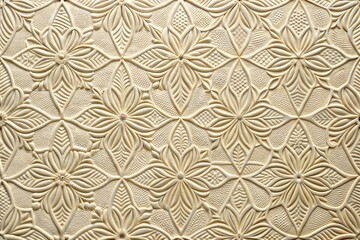 Close-up of intricate floral pattern on cream-colored clay