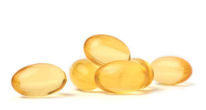 close-up macro view of fish oil capsules or pills isolated white background, dietary supplements rich in omega 3 fatty acids