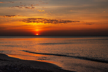 Sandy beach with pebbles of Baltic Sea on Curonian Spit at sunset. Kaliningrad region. Russia