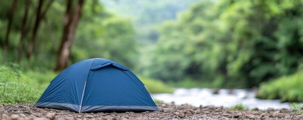 Camping tent in a forest by the river