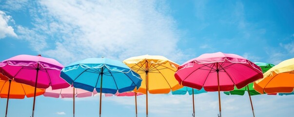 Vibrant beach umbrellas contrasting with a clear summer sky