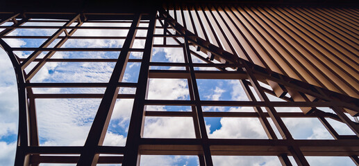 A structure featuring wooden slats on construction site contributing to its architectural style