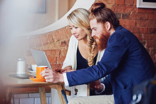 Video call, cafe and laptop with remote working and team meeting on a project with staff. Diversity, web designer and coffee shop with planning and technology with collaboration and design idea - Powered by Adobe