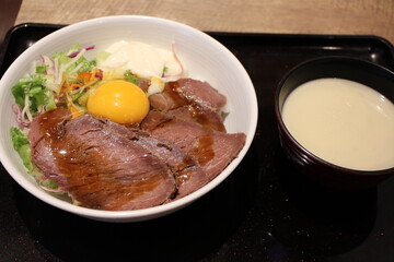 Japanese cuisine: ostrich meat bowl with raw egg in Tokyo, Japan