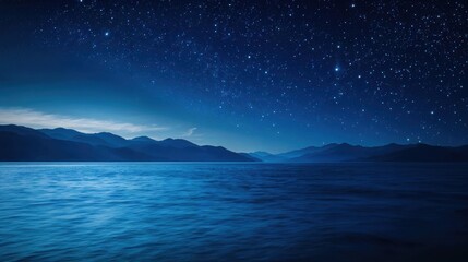 Night sky reflecting on calm water with mountains background
