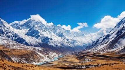 Fototapeta premium Stunning panoramic view of the Himalayas with snow-capped mountains, a blue sky, and a winding river through the valley, epitomizing natural beauty and grandeur.