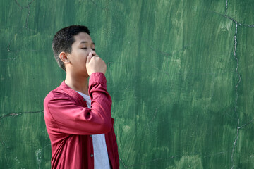 A teenager is covering their mouth.