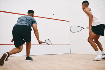 Sports, men and play squash for game, exercise and athlete training together for fitness. Racket, friends or players in competition at indoor court for workout match, body health or back view at club
