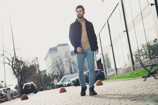 Photo of handsome nice man wear stylish clothes outfir spending weekend walking city street autumn day outside