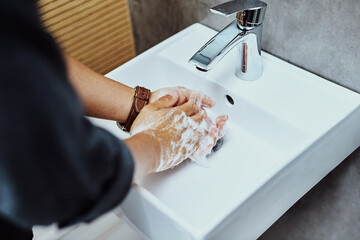 Washing hands, person and basin with liquid soap for hygiene, bacteria and germs. Above, bathroom and water with prevention for safety, protection and disinfection with dirt removal and self care