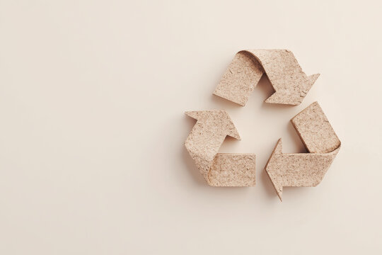 Cork Recycling Symbol on Minimalist Beige Background, A recycling symbol made from cork material, placed on a beige background, representing eco-friendly and sustainable practices

 - Powered by Adobe