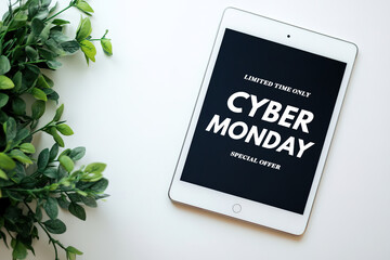 Tablet screen showing Cyber Monday ad beside green plant