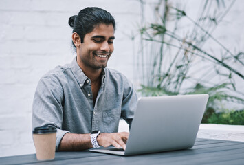 Employee, man and happy at cafe on laptop with coffee for research with creative ideas as website designer. Business, male person and smile for remote work with browsing internet as freelancer