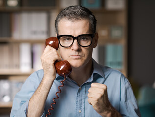 Angry businessman having a phone call