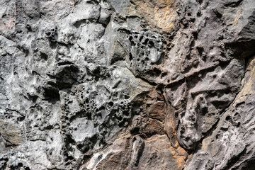 Natural structures and shapes from Iceland. Beautiful natural scenery for the background. Rock texture. Pattern, geometry, geology, light reflections. Structure of rocks inside a cave.