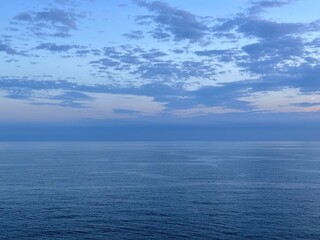 Blue sea and dark clouds in sky at evening. 