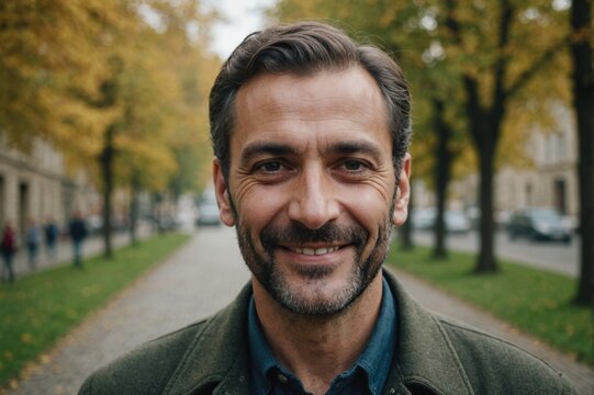 Close portrait of a smiling 40s Georgian man looking at the camera, Georgian outdoors blurred background