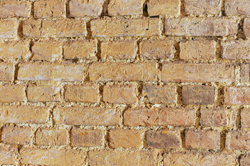 Old weathered grunge brick wall texture background in warm colors