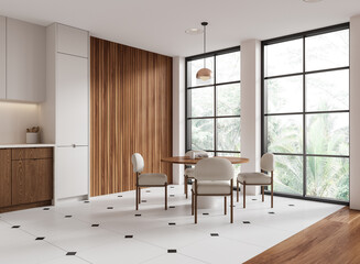 Home kitchen interior with dinner table and cooking cabinet. Panoramic window