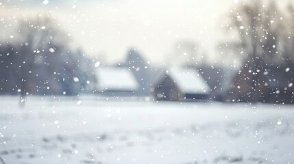 Blurred view of snow-covered countryside with distant farmhouse and soft snowfall