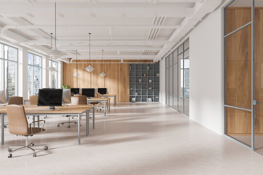 Spacious modern open space office with desks, chairs, computers, and city view through large windows in a loft-style interior. Concept of coworking. 3D Rendering