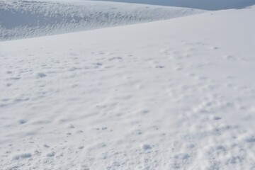 A detailed close-up of snow on a mountain slope, showcasing the textures of the snowy landscape. Great for winter, adventure, and nature themes.