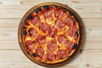 Tasty pepperoni pizza on wooden table, top view, copy space