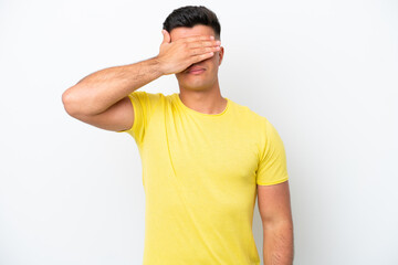 Young caucasian handsome man isolated on white background covering eyes by hands. Do not want to...