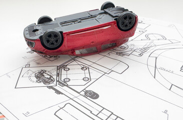 Small toy car close up image on blueprint background.