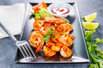 Grilled shrimp with dipping sauce. Ideal for seafood lovers and gourmet meal presentations
