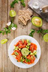 Smoked salmon salad with avocado and lettuce on a plate. Ideal for healthy, fresh, and gourmet meals