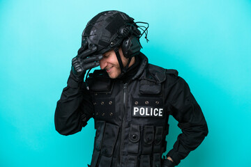 SWAT caucasian man isolated on blue background laughing