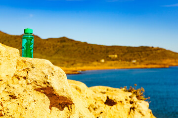 Coast landscape with bottle of water