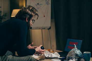 Shaping Worldview: Man Stares at Laptop Screen with 'Don't Think!' Message