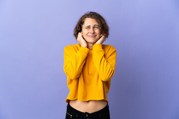 Young English woman isolated on purple background frustrated and covering ears