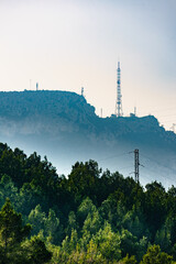 Obraz premium Tower mast and electricity transmission pylons in mountains