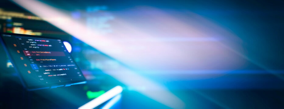 Writing programming code on laptop. Software source code. Programming code. Abstract IT technology background.