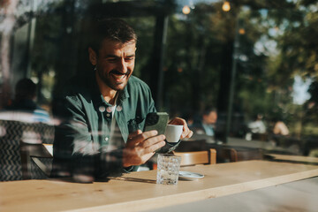 Toughtful man savoring coffee alone at a cozy cafe on a sunny day while lost in contemplation by the window