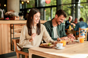 Enjoying a delightful brunch together at a cozy cafe on a sunny afternoon in the heart of the city