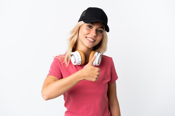 Young Russian woman listening music isolated on white background giving a thumbs up gesture