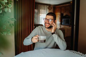 Young caucasian man is using mobile phone to send messages sms and talk	