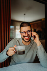 Young caucasian man is using mobile phone to send messages sms and talk	