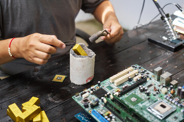 Factory worker overseas molten metal pouring into mold, surrounded by glowing heat in a steel foundry. Microchips and computer hardware components semiconductor and gold metal manufacturing.
