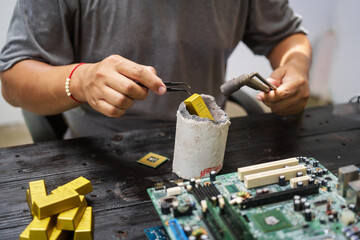 Factory worker overseas molten metal pouring into mold, surrounded by glowing heat in a steel foundry. Microchips and computer hardware components semiconductor and gold metal manufacturing.