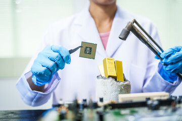 Factory worker overseas molten metal pouring into mold, surrounded by glowing heat in a steel foundry. Microchips and computer hardware components semiconductor and gold metal manufacturing.